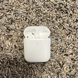 Left AirPod and Charging Case